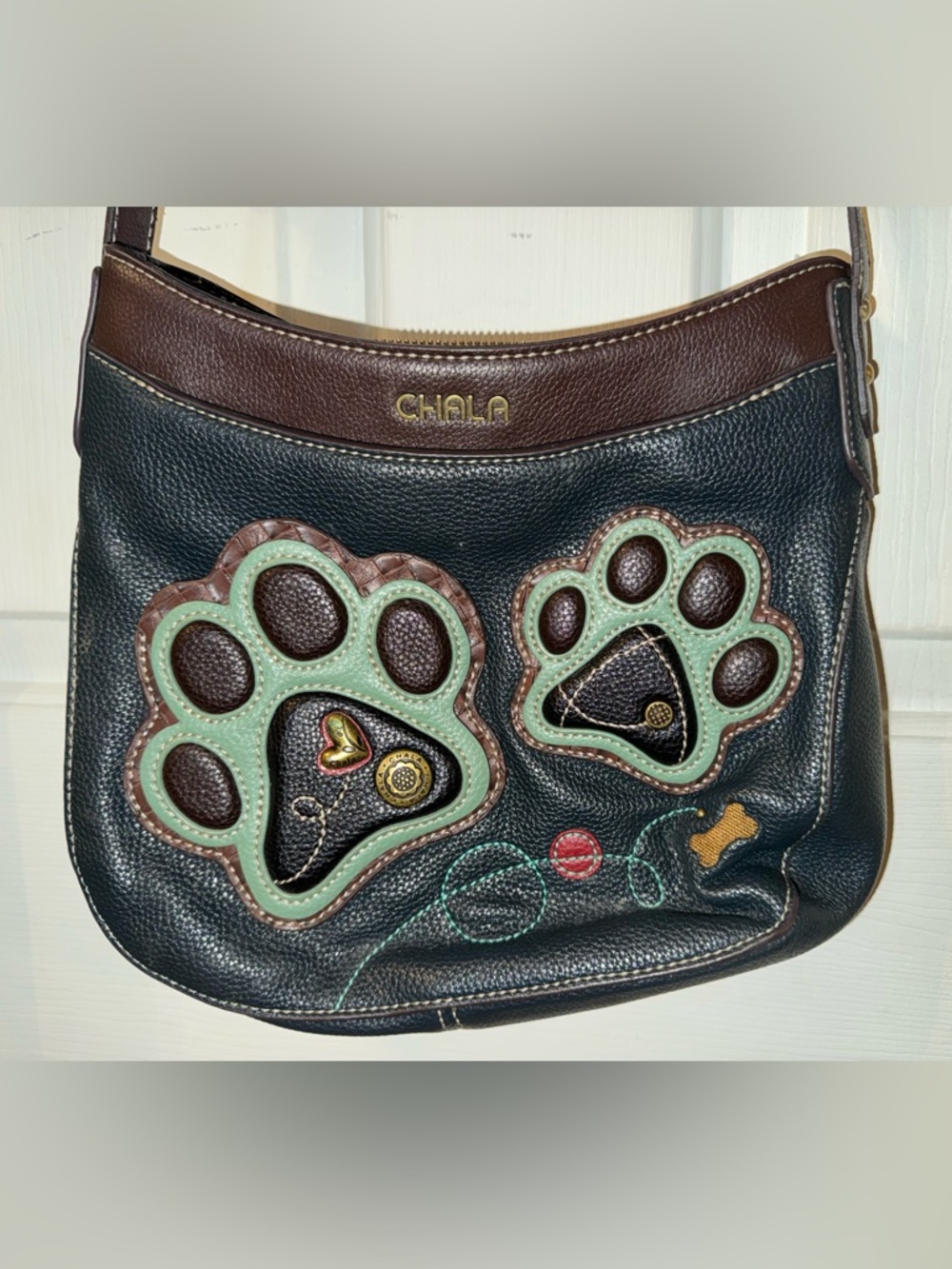 Chala Black Leather Paw Appliqué Crossbody Bag with Brown Trim and Mint Accents
